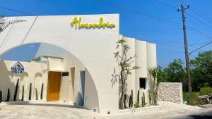 a white building with an arch entrance at Fulton Villa Alexandria 2BR in Sleman +29 photos