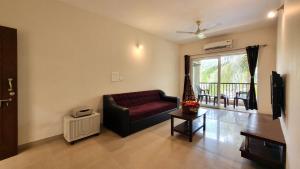 a living room with a couch and a window at Goa Chillout Apartment - 1BHK, Baga in Baga
