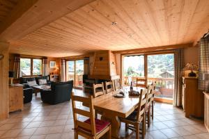 Un comedor con mesa y sillas de madera. en Chalet Anou - proche pistes de ski, en Le Chinaillon