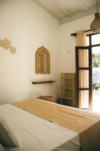 a bedroom with a large bed and a window at Casa Sinabowewa in Ahangama