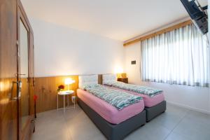 Ένα ή περισσότερα κρεβάτια σε δωμάτιο στο B&b Stregatto dalla Luna