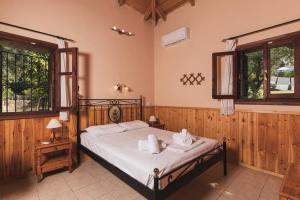 a bedroom with a bed with towels on it at Artemis Vassilikos in Vasilikos