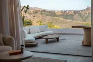 a living room with a couch and a large window at Palo Alto 9 Panoramic Views Terrace Luxury in Monda