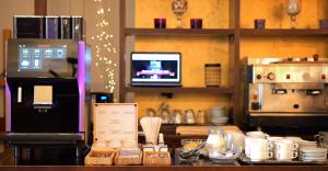 a kitchen with a counter top with a coffee machine at Hotel Maxim in Arad +25 photos