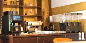 a kitchen with a counter with a coffee machine at Hotel Maxim in Arad