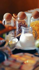 a group of glass jars filled with different types of food at Hotel Maxim in Arad