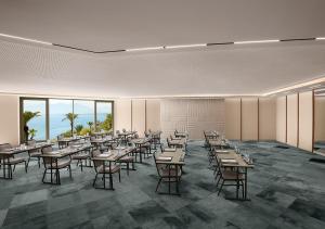 a dining room with tables and chairs and windows at Akra Antalya in Antalya +100 photos
