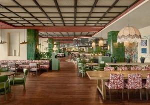 a restaurant with tables and chairs in a room at Akra Antalya in Antalya