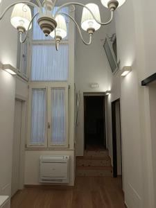 a hallway with a chandelier and stairs in a building at Ionian Breeze in Taranto