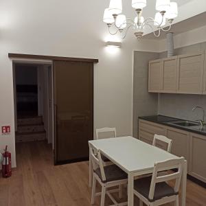 a kitchen with a table and chairs in a room at Ionian Breeze in Taranto