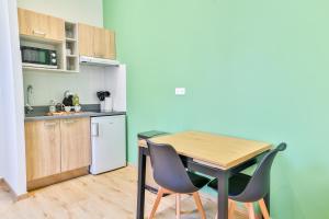 une cuisine avec une table et des chaises dans une pièce dans l'établissement Le Saint Colette #Parking privé et sécurisé, à Cognac 6 autres photos