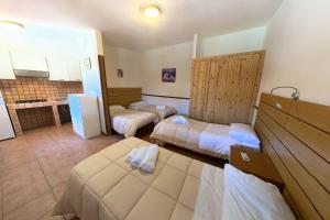 ein Hotelzimmer mit zwei Betten und einer Küche in der Unterkunft Onda Camping Village in Ardea