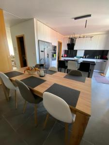 een keuken en eetkamer met een houten tafel en stoelen bij Casa do Moinho Vedro in Quintiães