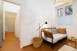 a living room with a couch and a window at U Canetta 2 in Pietra Ligure