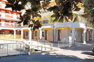 a building with yellow awnings on a city street at U Canetta 2 in Pietra Ligure