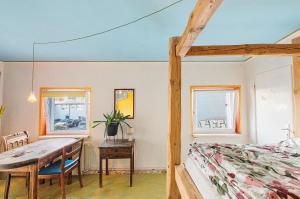 a dining room with a table and a bed at Fuchsbau In Der Ktv in Gehlsdorf