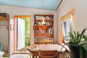 a dining room with a table and a book shelf at Fuchsbau In Der Ktv in Gehlsdorf