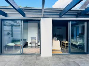 a glass extension to a house with a patio at La Paillote in Loctudy
