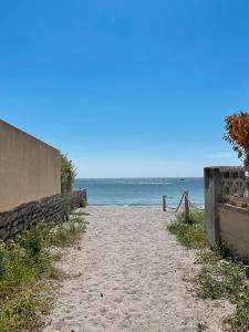 an empty beach with the ocean in the background at La Paillote in Loctudy