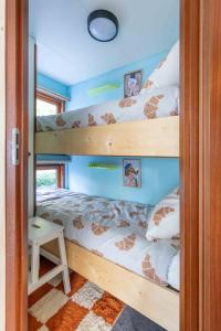 a bedroom with two bunk beds in a house at Tiny Cabin Sole op de Veluwe in Putten
