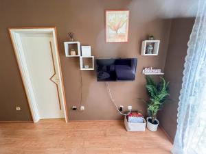 a room with a flat screen tv and a door at Apartment Pali in Klek