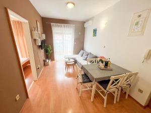 a living room with a table and a couch at Apartment Pali in Klek