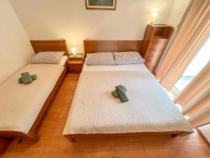 two beds in a room with two shoes on them at Apartment Pali in Klek