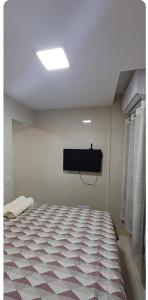 a room with a bed and a flat screen tv at Maison Chateaubriand Residence in Maceió +6 photos