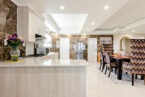 a large kitchen with a table and a dining room at Gosheni Villas in White River