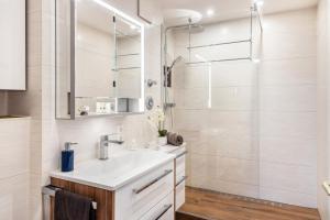 a bathroom with a sink and a shower at Nahe Airport Ber Adlershof in Schönefeld +14 photos