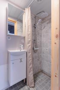 a white bathroom with a shower and a sink at Rakvere Old Town Home in Rakvere