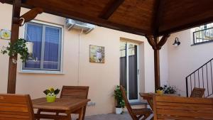 a patio with a table and chairs and a house at B&B Villa Letizia Inn in Castelbuono