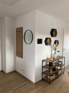 a room with a table and a mirror on a wall at Ferienwohnung Auszeit in Marsberg
