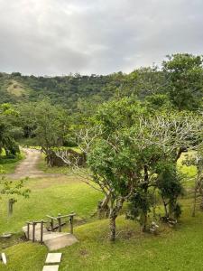 a park with a bench and trees in a field at Eden Wilds 42 in Port Edward