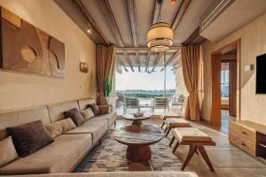 a living room with a couch and a table at Azur White Resort Ras El Hekma in Zāwiyat al ‘Awwāmah