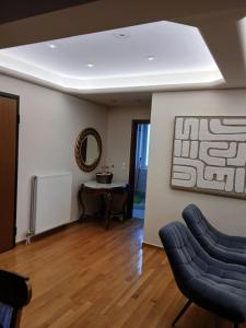 a living room with two chairs and a table at Stylish Luxury 3 Bd Penthouse in Drosia Center in Drosia