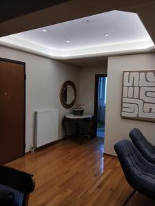 a living room with a table and two chairs at Stylish Luxury 3 Bd Penthouse in Drosia Center in Drosia +9 photos