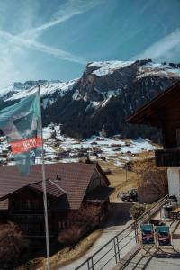 a flag in front of a lodge with a mountain at Chalet Brauerei in Lenk