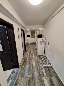 an empty room with a kitchen with a refrigerator at Petit Blue in Dudu