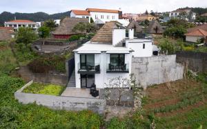 a white house on top of a hill at Casa da Mãe in Santana