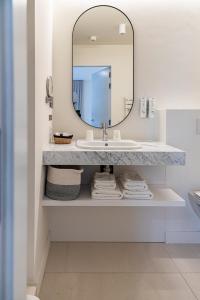 a bathroom with a sink and a mirror at Hotel Bell-X Kortrijk-Wevelgem in Wevelgem