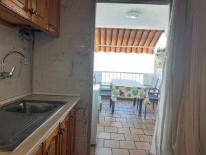 a kitchen with a sink and a table with chairs at House with balcony and views of the Atlantic in El Pris in El Pris