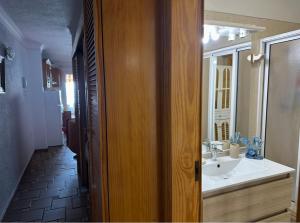 a bathroom with a sink and a mirror at House with balcony and views of the Atlantic in El Pris in El Pris