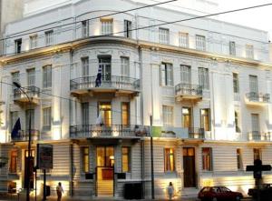 a large white building on the corner of a street at Art Hotel Athens in Athens