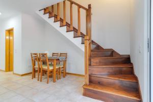 ein Esszimmer mit einer Treppe und einem Tisch mit Stühlen in der Unterkunft Villa Sunny Holiday by HR Madeira in Ponta do Sol + 11 Fotos
