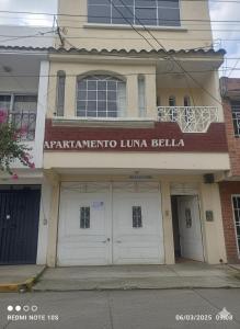 a building with two garage doors on a street at Apartamento Luna Bella in Quetzaltenango