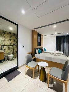 a hotel room with a bed and a bathroom at ROOTS A Unit of Coastal Dine Restaurant & Lodging in Bengaluru +116 photos