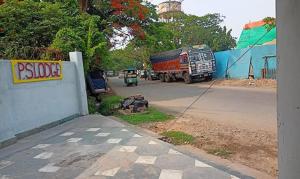 a truck is driving down a street with aphaltphaltphaltphalt at FabHotel Rose in kolkata