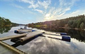 a boat is docked at a dock on a river at 1 Bedroom Cozy Home In Førde I Hordaland in Erve +11 photos