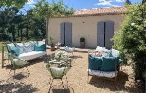 a patio with a couch and chairs and a table at Maison Avec Piscine in La Roque-Esclapon